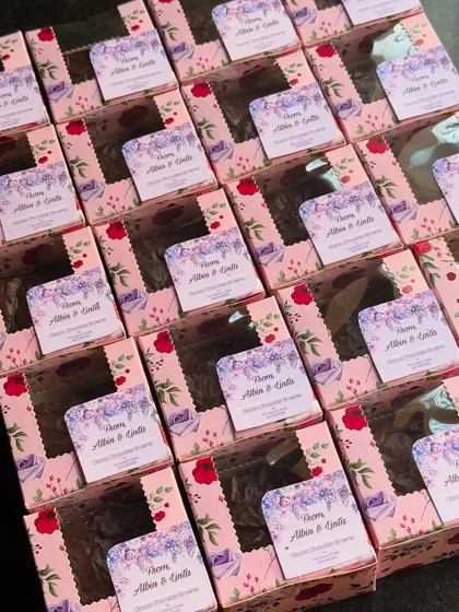 A large batch of my classic chocolate brownie return favors, all packed and ready for a special event. They are a delicious way to thank your guests.