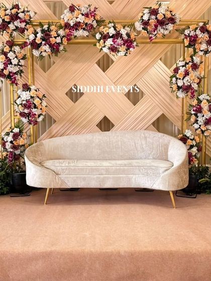 A heart-shaped floral frame made of multi-toned flowers creates a beautiful and romantic backdrop for this elegant engagement stage.