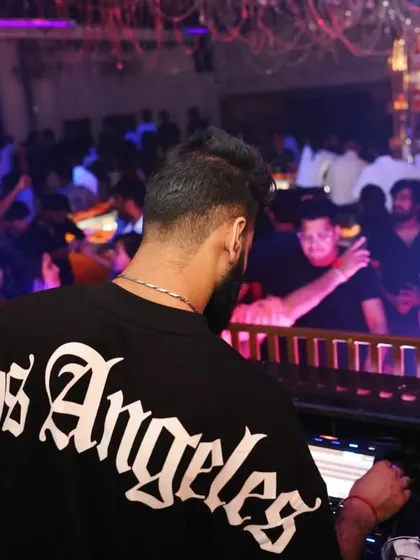 A view of the crowd from my station. Seeing people lose themselves in the music is the ultimate reward. I curate my sets with a mix of genres to make sure there is something for everyone.