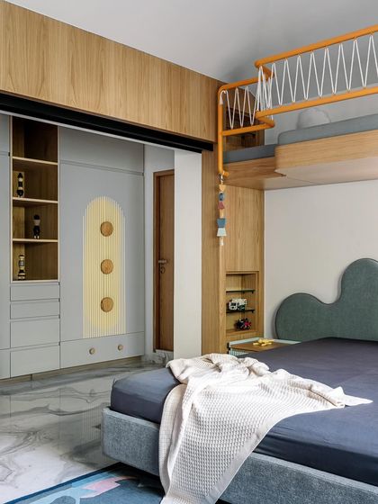 For this children's room in Cocoon House, we created a playful yet functional space with a custom bunk bed and integrated storage. The design uses a soft color palette with pops of yellow, while the cloud-shaped headboard and whimsical details spark imagination without creating clutter.