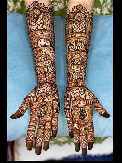 A clear, full view of the animal motif mehandi, showing the beautiful symmetry and detailed artwork covering both arms.