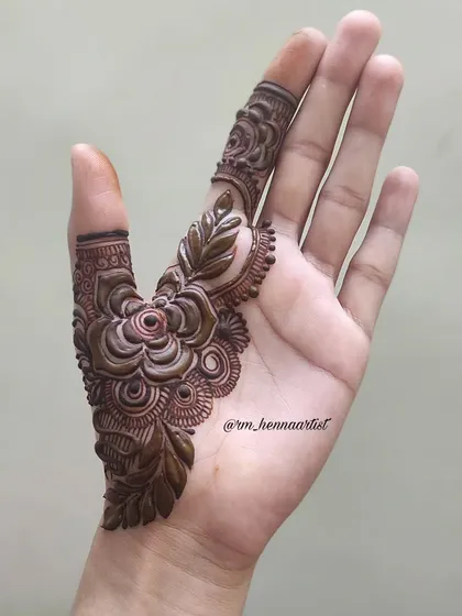 Step one of this floral design. It all starts with a single, beautifully detailed flower on the thumb.
