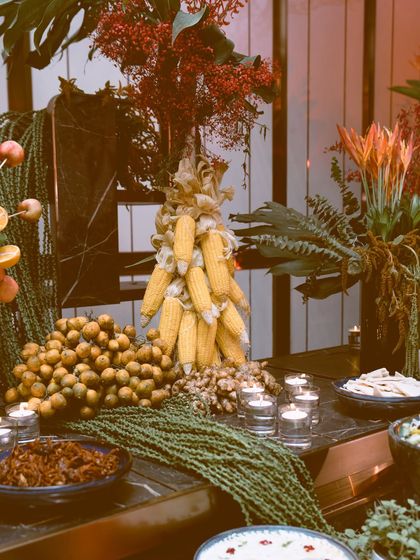 Every detail is a deliberate choice. A sculptural centerpiece made of fresh corn cobs stands beside a bounty of longan fruit, showcasing my method of using natural, edible ingredients as decorative elements within the food styling itself.