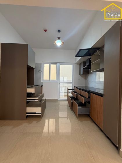 This image shows the full scope of a kitchen and utility area we designed, with ample storage, an open layout, and plenty of natural light.