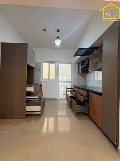 This image shows the full scope of a kitchen and utility area we designed, with ample storage, an open layout, and plenty of natural light.