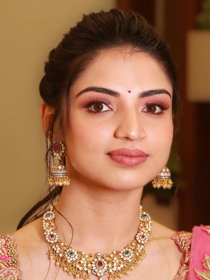 A close-up of the beautiful pink eyeshadow and perfectly defined brows for this soft glam style.