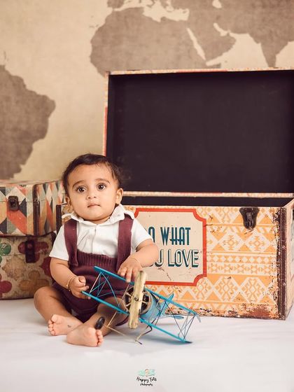 Adventure awaits our little traveler. This vintage explorer theme uses a world map backdrop, old-fashioned suitcases, and a toy airplane to inspire wanderlust.