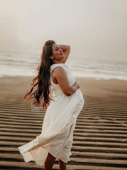The wind in her hair, the ocean behind her. This solo portrait on the beach captures a feeling of freedom and powerful femininity during her pregnancy.