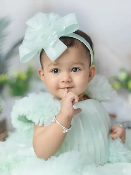 A sweet, shy moment. The little finger to her lips is an adorable, candid gesture.
