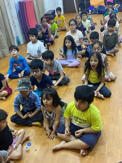 We introduce children to the practice of mindfulness and calm from a young age. Here, young campers take a moment for quiet meditation, learning to focus their minds after a session of active play.