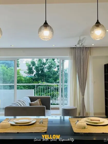 A view from the kitchen island into the living area, showing how we use accent colors like yellow to connect different zones in an open-plan space.