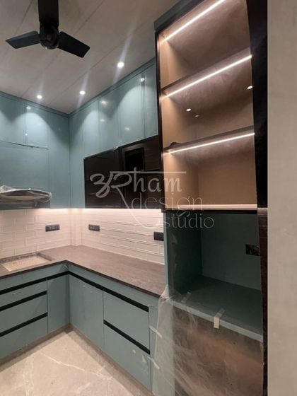 This modern kitchen showcases our love for functional beauty. We used a soothing green palette for the cabinetry, combining solid surfaces with fluted glass and integrated under-cabinet lighting to create a workspace that is both stylish and practical.
