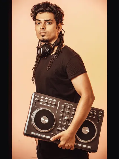 A shot of me with my Numark Mixtrack Pro controller. This is the gear I use to bring your ideas to life, crafting every beat and transition from my studio.