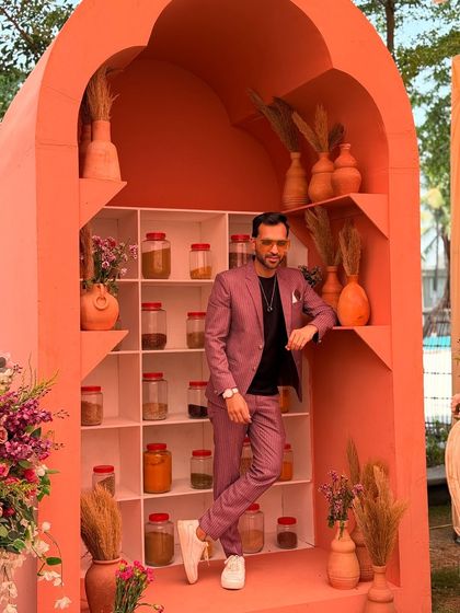 A full shot of my suit against a unique, spice-themed decor. I love when my outfit complements the creative backdrops at events.