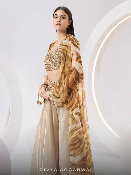 The Adoree Cape Set, a vision of modern elegance with its printed oversized cape and hand-adorned bustier.