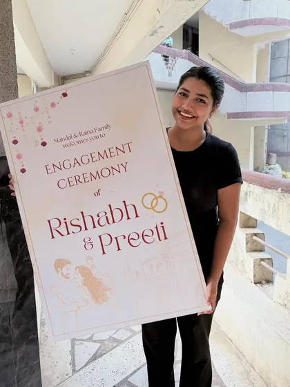 There's nothing like seeing a design come to life. Here I am with the finished engagement ceremony welcome sign for Rishabh and Preeti. A personalized welcome sign at the entrance sets a warm and inviting tone for the celebration.