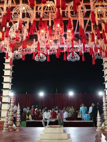 A view from under the grand mandap, looking out at the ceremony space. The structure was designed to feel both grand and intimate for the couple's pheras.