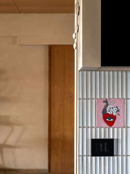 Our clients collected unique tiles from their travels, which we embedded into the home's design. This heart tile in the kitchen is an ode to their love for cooking and gathering in the space closest to their hearts.