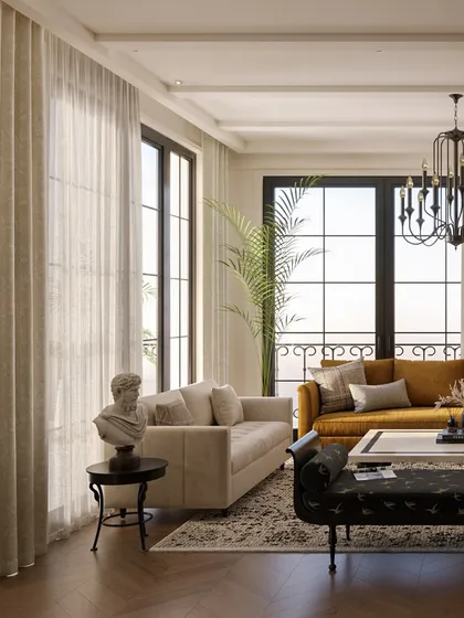 Large, dark-framed windows flood this living room with natural light, creating a bright and airy atmosphere. We paired classic furniture silhouettes with earthy tones like mustard and beige to craft a space that feels both sophisticated and comfortable.