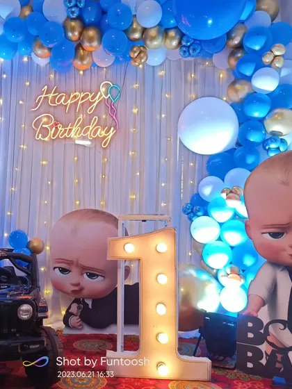 Another angle of the Boss Baby first birthday decoration, highlighting the light-up marquee number and the toy jeep prop that adds a playful element for the kids.