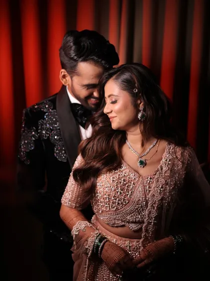 A romantic moment between the couple. The bride's makeup is soft and glowing, perfect for a night of love and celebration.
