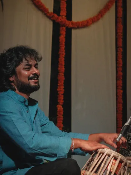 A smiling moment captured during a performance at the Courtyard Baithak series.