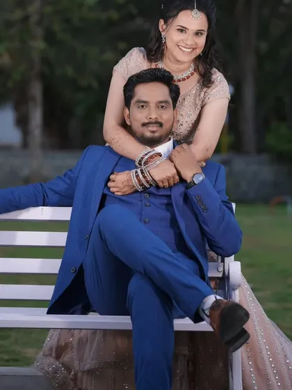 A lovely couple portrait from their reception. The bride's soft pink lehenga and glowing makeup look stunning next to the groom's sharp blue suit.
