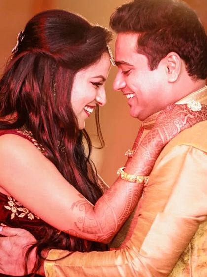 A warm and joyful close-up of a couple sharing an intimate moment. The soft lighting and their happy expressions make this a heartwarming and lovely candid portrait.