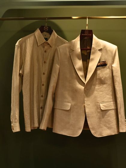A coordinated set of a beige blazer and a striped shirt. This pairing demonstrates how our pieces can be combined for a cohesive and effortlessly stylish look.