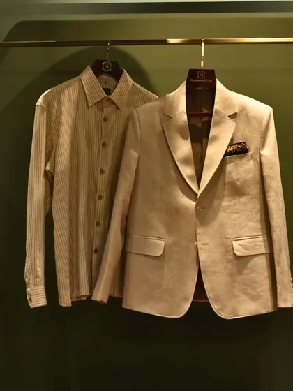 A coordinated set of a beige blazer and a striped shirt. This pairing demonstrates how our pieces can be combined for a cohesive and effortlessly stylish look.