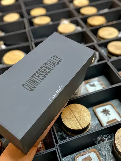 This is a custom corporate gift box we designed for a client, featuring their brand name "Quintessentially" on the lid. We manage the entire process, from sourcing the box to filling it with our handcrafted products, ensuring a professional and high-quality result.