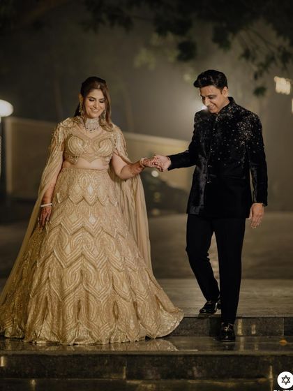 Our beautiful client looks radiant celebrating 25 years of love in a champagne gold, fully embellished lehenga crafted with our signature embroidery.