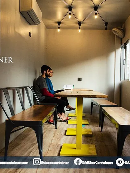 We maximize natural light in our designs to foster a warm and revitalizing environment. This space in 'Cafe Infinity' is perfect for work or casual meetings, featuring custom-built furniture.