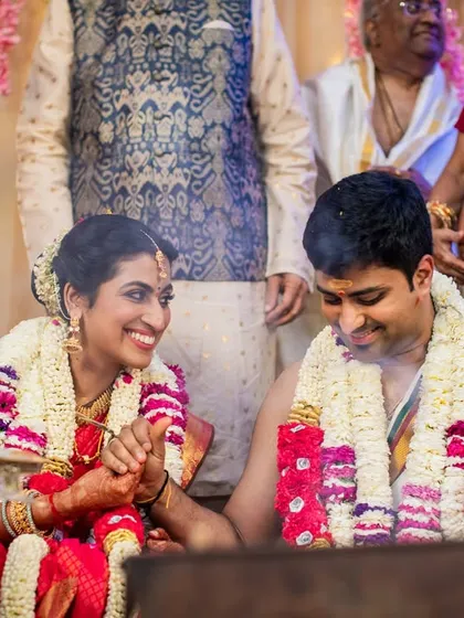 A happy moment between a Sindhi bride and her Tamilian groom, capturing the joy of their cross-cultural union.