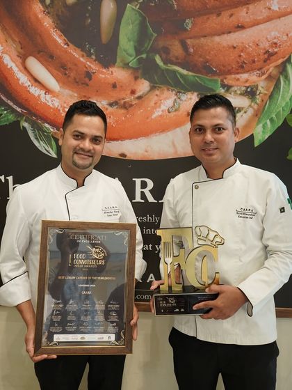 Two of our senior chefs proudly holding the award and certificate. Their leadership and expertise are invaluable to our success.