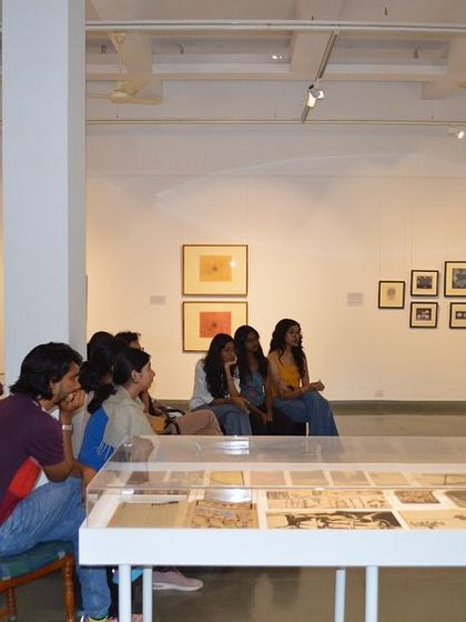 The students engrossed in the video presentation at the Gulammohammed Sheikh exhibition.