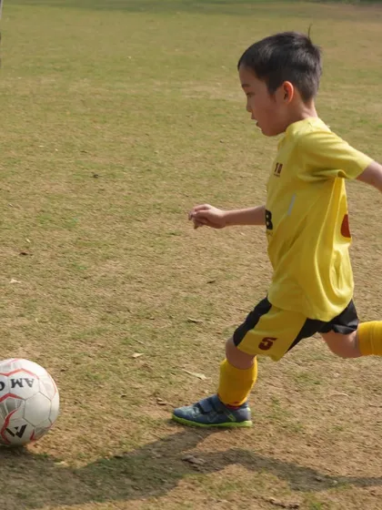 A young player takes a shot. Every kick is an opportunity for growth, happiness, and learning the value of hard work.