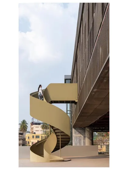 A sculptural spiral staircase connects the old and new sections of our Hoverspace project. This element acts as a visual and programmatic pause point, creating a distinct transition between the existing terrace and the new office space above.