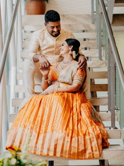 A candid moment of laughter between the couple. Their comfortable yet elegant outfits were designed for celebrating special moments together.
