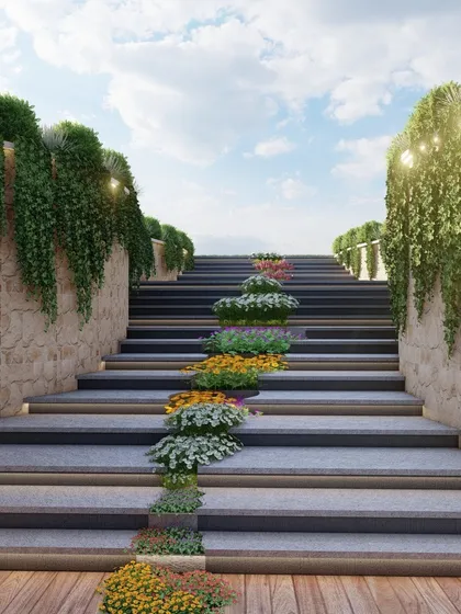 A view from the bottom of the floral staircase, looking up towards the sky. Integrated lighting under the steps ensures safety and adds a dramatic effect at night, highlighting the beauty of the structure and plantings.