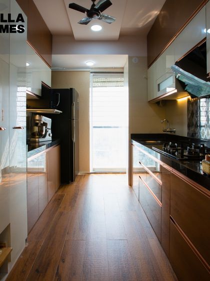 A full-length view of the kitchen, showcasing the sleek, easy-to-maintain surfaces and ample ventilation from the large window.