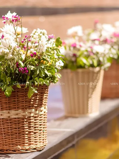 Another view of the charming wicker baskets filled with flowers, a simple yet effective decor element.