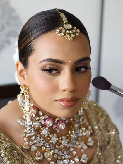 This bride chose a stunning golden-ivory lehenga for her wedding day. I teach how to create a clean, sophisticated look with a sharp winged liner to complement such elegant attire.