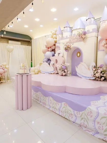 A side view of the princess castle stage, showing the custom-printed floor decal and the pink ball pit area.