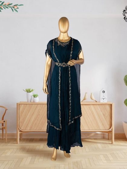 This dark teal layered ensemble features a flowing dress with cape-like sleeves and an embroidered belt. It's a unique piece from my hand-stitched collection, perfect for making a sophisticated statement.