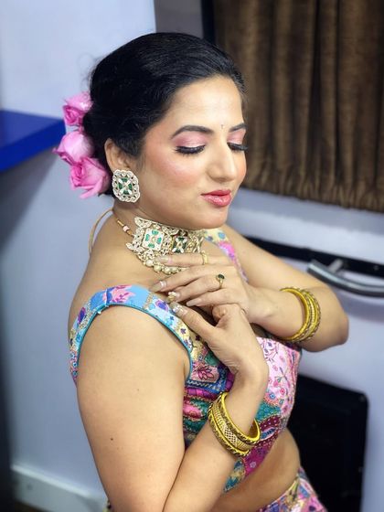 A beautiful pose showing off the soft makeup and the elegant hairstyle.