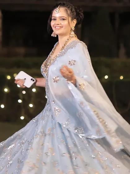 A twirl to show off the flowing lehenga. The makeup is designed to be flawless from every angle.