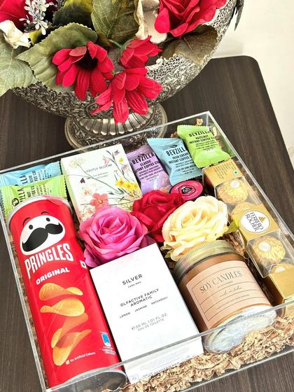 Our acrylic box hampers are perfect for any occasion. This one is customized for a couple, with "his and hers" Zara perfumes, Pringles, Ferrero Rocher, and a scented candle.