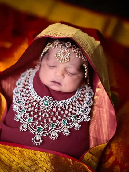 A precious newborn adorned with traditional jewelry, blending cultural heritage with the innocence of a new life.