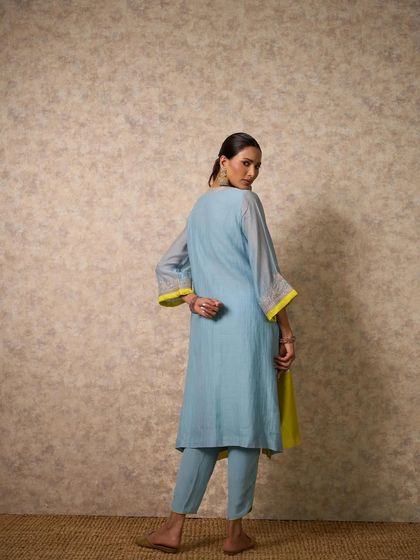 The back view of the sky blue and lime yellow kurta set, showcasing its clean lines and refreshing color-blocking.